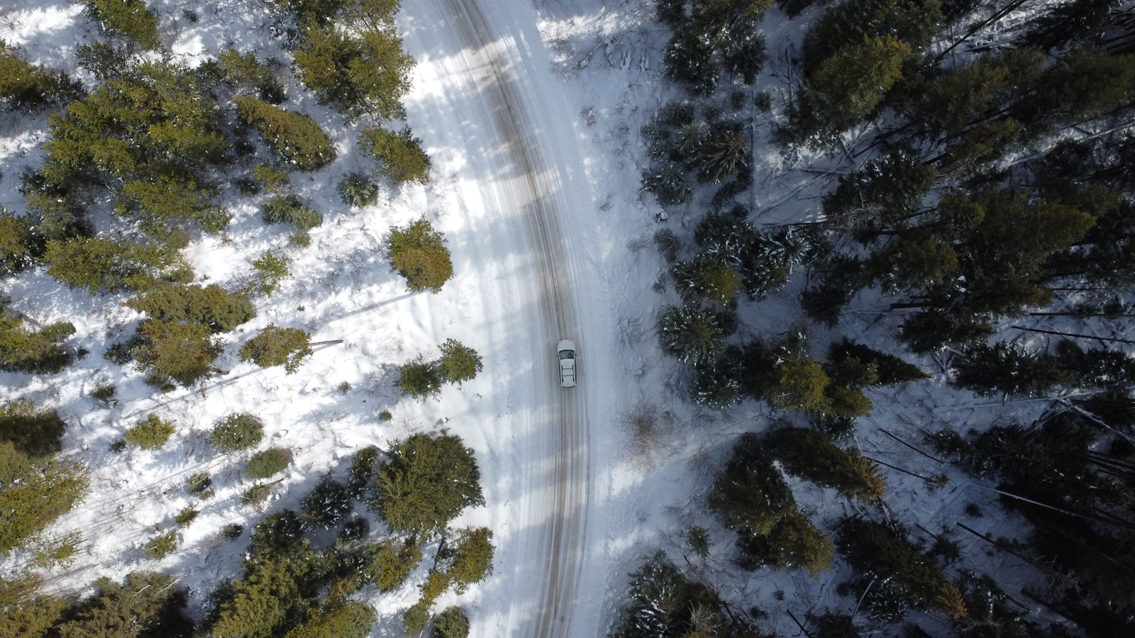 An aerial view of a snow covered road